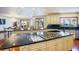 Open kitchen with large island, black countertop, wooden floors, and stainless steel appliances at 802 Druid S Rd, Clearwater, FL 33756