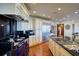 Gourmet kitchen with a blue stove, stainless steel fridge, and custom cabinetry at 802 Druid S Rd, Clearwater, FL 33756