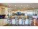 Spacious kitchen with an island, white cabinets, black countertops, and wooden bar stools at 802 Druid S Rd, Clearwater, FL 33756