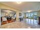 Elegant living room featuring marble floors, chandelier, and panoramic waterfront views at 802 Druid S Rd, Clearwater, FL 33756