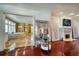 Open living space with a mirrored sculpture, fireplace, hardwood flooring, and easy access to the bathroom at 802 Druid S Rd, Clearwater, FL 33756