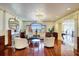 Luxurious living room showcasing hardwood floors, high ceilings, a chandelier, and bay view windows at 802 Druid S Rd, Clearwater, FL 33756