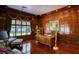 Stylish office with rich wood paneling, hardwood floors, a large window, and custom built-ins at 802 Druid S Rd, Clearwater, FL 33756