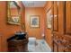 Unique powder room featuring textured walls, an ornate mirror, and a vessel sink on vanity at 802 Druid S Rd, Clearwater, FL 33756