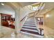 Elegant curved staircase with wood treads and white risers, connecting floors with refined style at 802 Druid S Rd, Clearwater, FL 33756