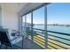 Relax on this balcony with seating and a stunning waterfront view of calm water and sunny skies at 8020 Sailboat Key S Blvd # 404, St Pete Beach, FL 33707