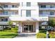 Beautiful building exterior with manicured landscaping, signage, and a welcoming entrance at 8020 Sailboat Key S Blvd # 404, St Pete Beach, FL 33707