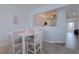 Cozy dining area with a modern table and chairs, with a view towards the bright kitchen at 8020 Sailboat Key S Blvd # 404, St Pete Beach, FL 33707