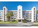 Beautiful, updated condominium complex with manicured landscaping, tropical palms, and a secure front entry at 8020 Sailboat Key S Blvd # 404, St Pete Beach, FL 33707
