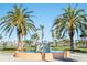 Beautiful fountain surrounded by lush greenery and palm trees on a sunny day at Coral Pointe at 8020 Sailboat Key S Blvd # 404, St Pete Beach, FL 33707