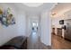 Inviting hallway with wood-look tile flooring, leading to the kitchen and living areas at 8020 Sailboat Key S Blvd # 404, St Pete Beach, FL 33707