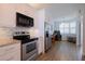 Bright kitchen with white cabinets, stainless steel appliances, and an open view to the office at 8020 Sailboat Key S Blvd # 404, St Pete Beach, FL 33707