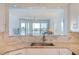Well-lit kitchen featuring granite countertops and backsplash with a sink overlooking the living area at 8020 Sailboat Key S Blvd # 404, St Pete Beach, FL 33707