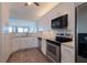 Modern kitchen with white cabinetry, stainless steel appliances, and stone countertops at 8020 Sailboat Key S Blvd # 404, St Pete Beach, FL 33707