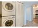 Practical laundry area with stacked washer/dryer and closet, conveniently located near the kitchen at 8020 Sailboat Key S Blvd # 404, St Pete Beach, FL 33707