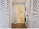 Convenient laundry area with a stacked washer and dryer, and wood-look tile floors at 8020 Sailboat Key S Blvd # 404, St Pete Beach, FL 33707