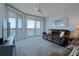 Bright living room with balcony access, offering stunning water views and comfortable seating at 8020 Sailboat Key S Blvd # 404, St Pete Beach, FL 33707