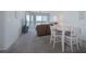 Inviting living room with plush carpet, neutral tones, and serene water views through large windows at 8020 Sailboat Key S Blvd # 404, St Pete Beach, FL 33707