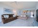 Cozy living room featuring plush carpeting, sofa, loveseat, and bright, airy atmosphere at 8020 Sailboat Key S Blvd # 404, St Pete Beach, FL 33707