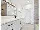 Bathroom featuring modern vanity, sleek fixtures, and tiled shower with gray accent wall at 9008 Lake Chase Island Way, Tampa, FL 33626