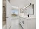 Updated bathroom features a vanity, tiled shower, and modern lighting fixtures at 9008 Lake Chase Island Way, Tampa, FL 33626