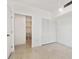 A bedroom featuring tile floors, a walk-in closet and an ensuite bathroom at 9008 Lake Chase Island Way, Tampa, FL 33626