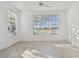 Sun-drenched bedroom featuring modern flooring and large windows with peaceful view at 9008 Lake Chase Island Way, Tampa, FL 33626
