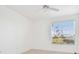 Bedroom with white walls, ceiling fan and a window looking out to a scenic view at 9008 Lake Chase Island Way, Tampa, FL 33626