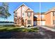 Charming two-story townhome featuring a well-maintained lawn and a serene lake view at 9008 Lake Chase Island Way, Tampa, FL 33626