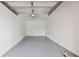 Interior view of a clean, empty garage featuring overhead lighting at 9008 Lake Chase Island Way, Tampa, FL 33626