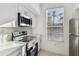 Modern kitchen featuring stainless steel appliances, white cabinets, and a stylish backsplash at 9008 Lake Chase Island Way, Tampa, FL 33626