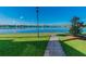 A lakeside walking path with views of the water, with homes visible in the distance at 9008 Lake Chase Island Way, Tampa, FL 33626