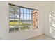 A picturesque view from the window shows a lake, a pathway, and a colorful building at 9008 Lake Chase Island Way, Tampa, FL 33626