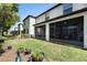 Spacious backyard with a screened in porch with green grass and blue sky at 10106 Corso Milano Dr, Tampa, FL 33625