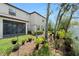 A well landscaped backyard with hanging plants and room to entertain and relax at 10106 Corso Milano Dr, Tampa, FL 33625