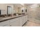 Well-appointed bathroom with double sinks, granite countertops, and a glass-enclosed shower for a spa-like feel at 10106 Corso Milano Dr, Tampa, FL 33625
