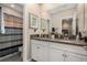 Bathroom with double sink vanity, granite countertop and shower with striped shower curtain at 10106 Corso Milano Dr, Tampa, FL 33625