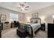 Comfortable bedroom with a cozy bed, ceiling fan, and desk area, offering a relaxing and functional space at 10106 Corso Milano Dr, Tampa, FL 33625