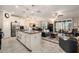 Open-concept kitchen with island and stainless steel appliances flowing into the living and dining areas at 10106 Corso Milano Dr, Tampa, FL 33625