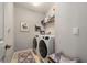 Clean laundry room featuring new white washer and dryer and patterned rug on floor at 10106 Corso Milano Dr, Tampa, FL 33625