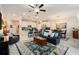 Open-concept living space with modern kitchen, comfortable seating, and stylish decor, with a ceiling fan at 10106 Corso Milano Dr, Tampa, FL 33625
