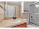 Bathroom featuring a sink with a tan countertop, a toilet, and a sliding glass door shower/tub combo at 1166 Grantham Dr, Sarasota, FL 34234