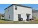 An expansive backyard features a patio with dining furniture and barbecue at 11944 Miracle Mile Dr, Riverview, FL 33578