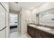 This bathroom has a double sink with granite countertops, white tile flooring, and a mirror at 11944 Miracle Mile Dr, Riverview, FL 33578