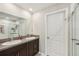 Clean bathroom with double sinks, granite countertops, shower, and tile flooring for a functional space at 11944 Miracle Mile Dr, Riverview, FL 33578