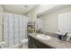 Bathroom featuring granite counters, large mirror, a toilet, and a shower with a blue turtle-themed curtain at 11944 Miracle Mile Dr, Riverview, FL 33578