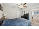 This bedroom features a ceiling fan, a closet, and a dark colored dresser at 11944 Miracle Mile Dr, Riverview, FL 33578