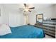 This bedroom has a ceiling fan, a closet, and a dresser with a mirror on top at 11944 Miracle Mile Dr, Riverview, FL 33578