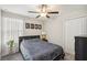 This bedroom has a ceiling fan, a window with white curtains, and a dark colored bed at 11944 Miracle Mile Dr, Riverview, FL 33578