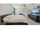 Inviting bedroom featuring a large bed, window with curtains, a dresser with a TV, and decor for a relaxed feel at 11944 Miracle Mile Dr, Riverview, FL 33578